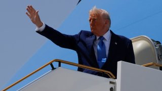 U.S. President Donald Trump gestures, while he boards Air Force One, in Abu Dhabi, United Arab Emirates, May 16, 2025.