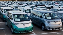 NATIONAL CITY, CALIFORNIA - APRIL 26: Rows of Volkswagen ID Buzz electric buses are parked at a vehicle processing lot at the National City Marine Terminal which is a major port for vehicle imports and exports, particularly for new foreign cars entering the United States on April 26, 2025 in National City, California. (Photo by Kevin Carter/Getty Images)